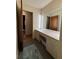Bathroom vanity with a large mirror and natural light, adjoining doorway at 285 Glen Ne Rd, Conyers, GA 30013