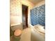 Bathroom with a tiled wall, toilet, and blue checkered shower curtain at 285 Glen Ne Rd, Conyers, GA 30013