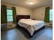 Bedroom with a large bed, green curtains, and natural light from windows at 285 Glen Ne Rd, Conyers, GA 30013
