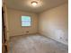 Neutral bedroom featuring carpeted floors and a window offering natural light at 285 Glen Ne Rd, Conyers, GA 30013