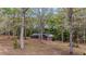 Secluded single-story home surrounded by tall trees and green landscaping at 285 Glen Ne Rd, Conyers, GA 30013