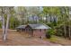 Brick home with green shutters nestled among mature trees at 285 Glen Ne Rd, Conyers, GA 30013