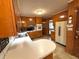 Well-lit kitchen with wooden cabinetry, stainless sink, and an eat-in peninsula at 285 Glen Ne Rd, Conyers, GA 30013
