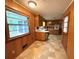Eat-in kitchen with wood cabinets, neutral countertops, and a view to the backyard through the window at 285 Glen Ne Rd, Conyers, GA 30013