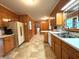 Functional kitchen with wood cabinets, neutral countertops, and a window over the sink at 285 Glen Ne Rd, Conyers, GA 30013