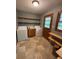 Practical laundry room with washer, dryer, shelves, and tiled flooring at 285 Glen Ne Rd, Conyers, GA 30013