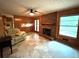 Cozy living room with a brick fireplace, wood paneled walls, and comfortable seating at 285 Glen Ne Rd, Conyers, GA 30013