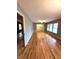 Spacious living room with light blue walls and gleaming hardwood floors, illuminated by large windows at 285 Glen Ne Rd, Conyers, GA 30013