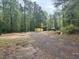A mostly cleared lot featuring a storage container with trees surrounding the property at 285 Glen Ne Rd, Conyers, GA 30013