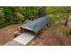 Aerial view of the home, featuring an attached carport and expansive driveway at 285 Glen Ne Rd, Conyers, GA 30013