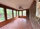 Bright sunroom with a brick accent wall and multiple large windows at 285 Glen Ne Rd, Conyers, GA 30013