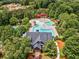 Aerial view of pool and clubhouse featuring mature trees and lush landscaping, perfect for outdoor enjoyment at 322 Tupelo Tr Trl, Canton, GA 30114