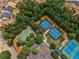 A beautiful aerial view of community tennis and basketball courts surrounded by lush green trees and landscaping at 322 Tupelo Tr Trl, Canton, GA 30114