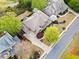 Aerial view of a home with mature trees, landscaping, and a concrete driveway on a sunny day at 322 Tupelo Tr Trl, Canton, GA 30114