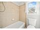 Bright bathroom featuring a combination shower and tub with neutral tile and modern fixtures at 322 Tupelo Tr Trl, Canton, GA 30114