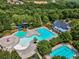Aerial view of the community pool, including a water slide and a lounge area surrounded by trees at 322 Tupelo Tr Trl, Canton, GA 30114