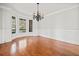 Spacious dining room with hardwood floors, wainscoting, and a stylish chandelier at 322 Tupelo Tr Trl, Canton, GA 30114