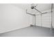 Clean and spacious two car garage with an epoxy floor, and access door at 322 Tupelo Tr Trl, Canton, GA 30114