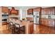 Spacious kitchen with stainless steel appliances, wood cabinets, large island, and four chairs at 322 Tupelo Tr Trl, Canton, GA 30114
