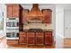 Kitchen with double ovens, cooktop, granite counters, wooden cabinets at 322 Tupelo Tr Trl, Canton, GA 30114
