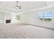 Spacious living room with plush carpeting, fireplace, and natural light from the windows at 322 Tupelo Tr Trl, Canton, GA 30114