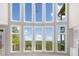Bright living room with a wall of windows offering stunning views of the lush landscape at 322 Tupelo Tr Trl, Canton, GA 30114