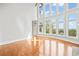 Open-concept living room with hardwood floors and wall of windows showcasing scenic views at 322 Tupelo Tr Trl, Canton, GA 30114