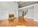 Spacious living area with stone fireplace, built-in shelving, and hardwood floors at 322 Tupelo Tr Trl, Canton, GA 30114