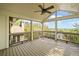Screened patio with wood floors, ceiling fan, and a view of the lush backyard at 322 Tupelo Tr Trl, Canton, GA 30114