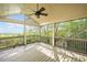 Screened patio with wood floors, ceiling fan, and a view of the lush backyard at 322 Tupelo Tr Trl, Canton, GA 30114