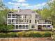 Expansive back of house featuring a two-story screened in porch and large decks overlooking the well-manicured lawn at 322 Tupelo Tr Trl, Canton, GA 30114