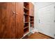 Walk-in closet with lots of custom, built-in wooden shelves, cabinets, and drawers for storage at 322 Tupelo Tr Trl, Canton, GA 30114
