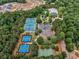Aerial view of the community tennis and basketball courts, surrounded by trees and parking spaces at 322 Tupelo Tr Trl, Canton, GA 30114