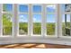 Bright room featuring multiple large windows offering a beautiful view of the trees and distant hills at 322 Tupelo Tr Trl, Canton, GA 30114