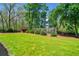 Expansive backyard with lush green lawn, mature trees, and a charming playhouse at 4504 Union Hill Rd, Canton, GA 30115