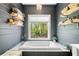Relaxing bathroom features a garden tub with views of the backyard at 4504 Union Hill Rd, Canton, GA 30115