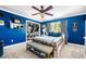 Bright blue bedroom with a ceiling fan, organized closet, and Yankees decor at 4504 Union Hill Rd, Canton, GA 30115