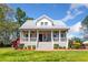 Inviting home exterior featuring a covered porch with white railings and a well-maintained lawn at 4504 Union Hill Rd, Canton, GA 30115