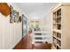 Inviting hallway featuring hardwood floors, a sliding barn door, and built-in bookshelves at 4504 Union Hill Rd, Canton, GA 30115