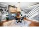 The open-concept kitchen features dark appliances, a brick fireplace, and stairs to the upper level at 4504 Union Hill Rd, Canton, GA 30115