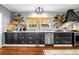 Modern kitchen featuring dark cabinets, stainless steel appliances, and floating wooden shelves at 4504 Union Hill Rd, Canton, GA 30115