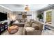 Comfortable living room area with L-shaped sofa, decorative accents, and an office space at 4504 Union Hill Rd, Canton, GA 30115
