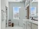 Bright bathroom showcasing a modern vanity, white cabinets, and a window with blinds for natural light at 1332 Nw Creekside Cir, Atlanta, GA 30318