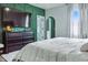 Modern bedroom features a large wall-mounted TV, stylish dresser, and decorative geometric wall paneling at 1332 Nw Creekside Cir, Atlanta, GA 30318