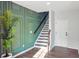 Entryway featuring a staircase, stylish wall trim, and hard flooring at 1332 Nw Creekside Cir, Atlanta, GA 30318