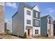 Charming two-story home with a modern white and grey facade, an orange front door, and dark window shutters at 1332 Nw Creekside Cir, Atlanta, GA 30318