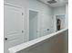 Hallway featuring doors to bedrooms and a view to a bathroom at 1332 Nw Creekside Cir, Atlanta, GA 30318