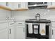 Modern kitchen featuring white cabinets, stainless steel appliances, and stylish accents at 1332 Nw Creekside Cir, Atlanta, GA 30318