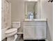 This bathroom features a white vanity, a toilet, black tile floors, and a shower with a patterned curtain at 1668 Sabastian Ne Pt, Atlanta, GA 30329