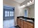 Bright bathroom featuring a dual sink vanity with granite countertops and views into an adjacent bedroom at 1668 Sabastian Ne Pt, Atlanta, GA 30329